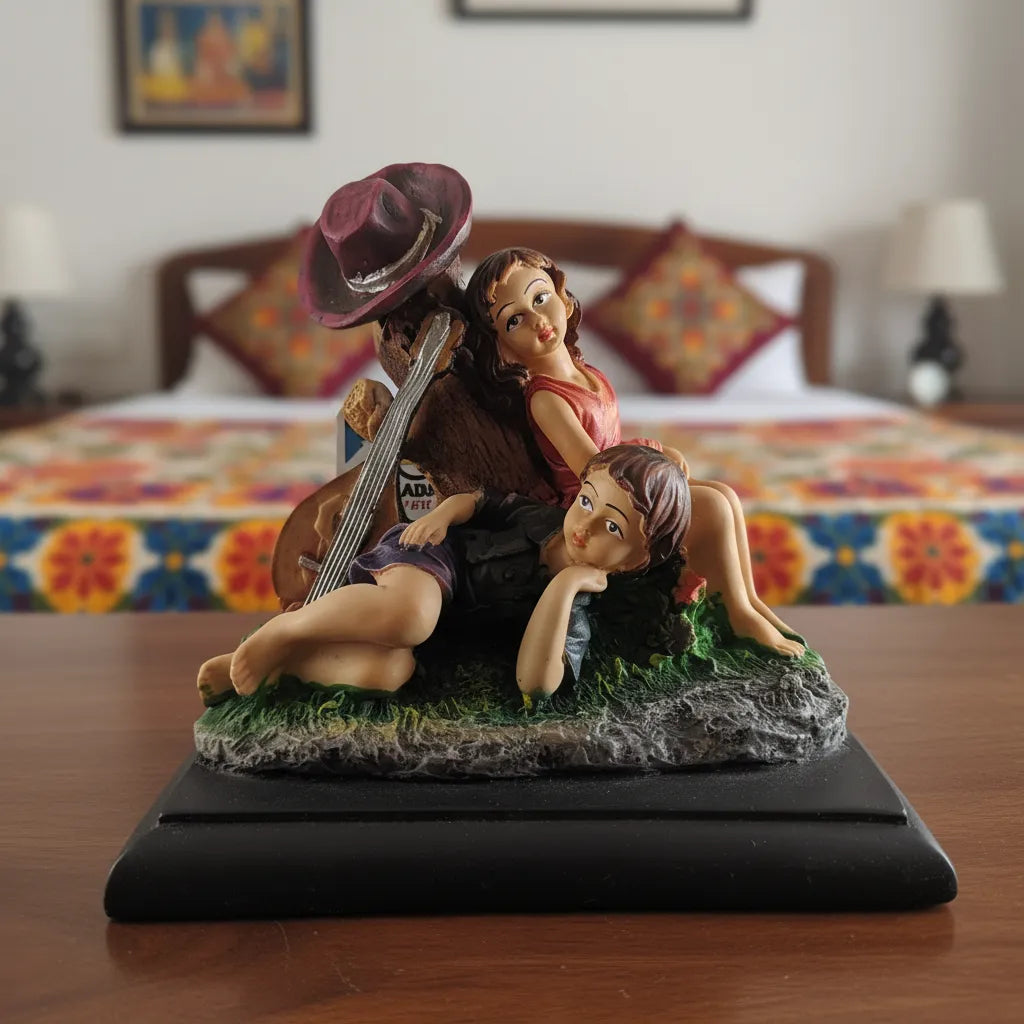 Decorative figurine of a couple with a guitar on a bed with colorful bedding in the background