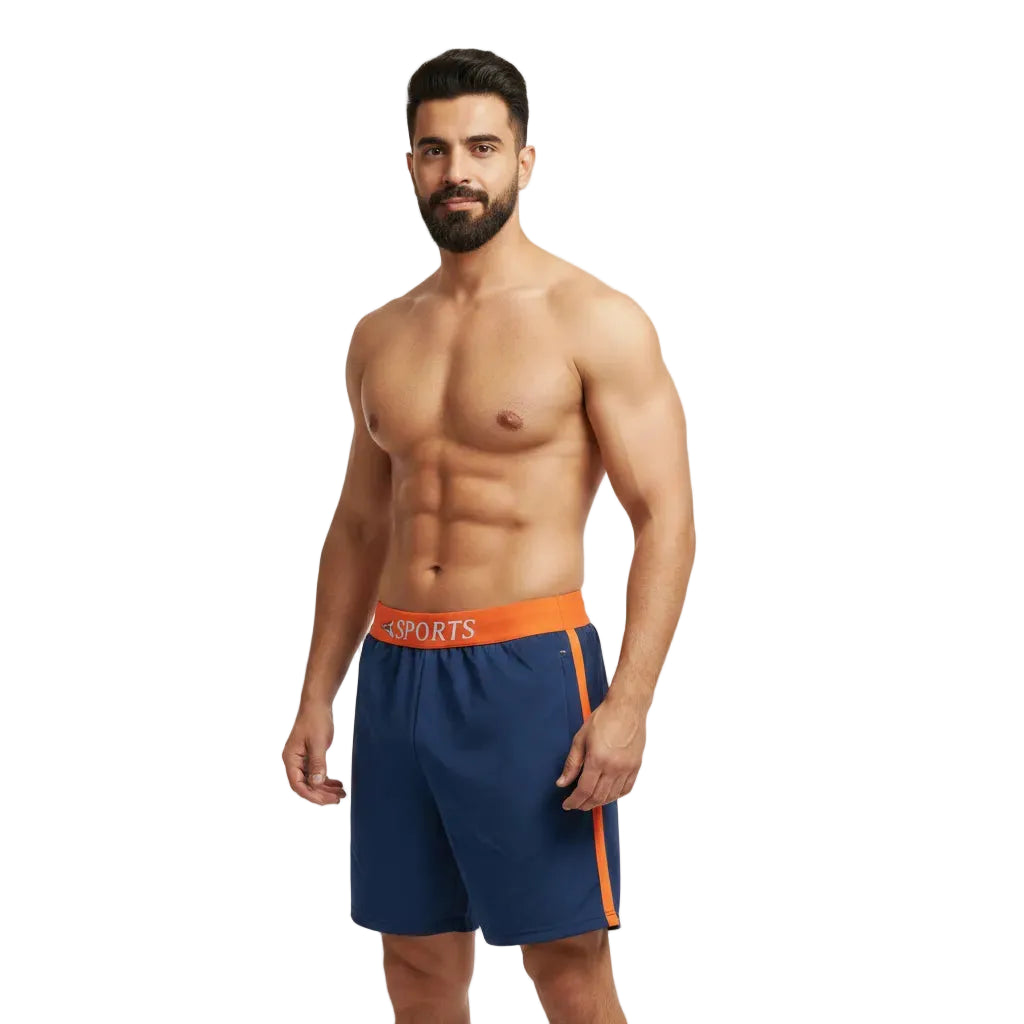 Man wearing blue athletic shorts with orange waistband on a white background