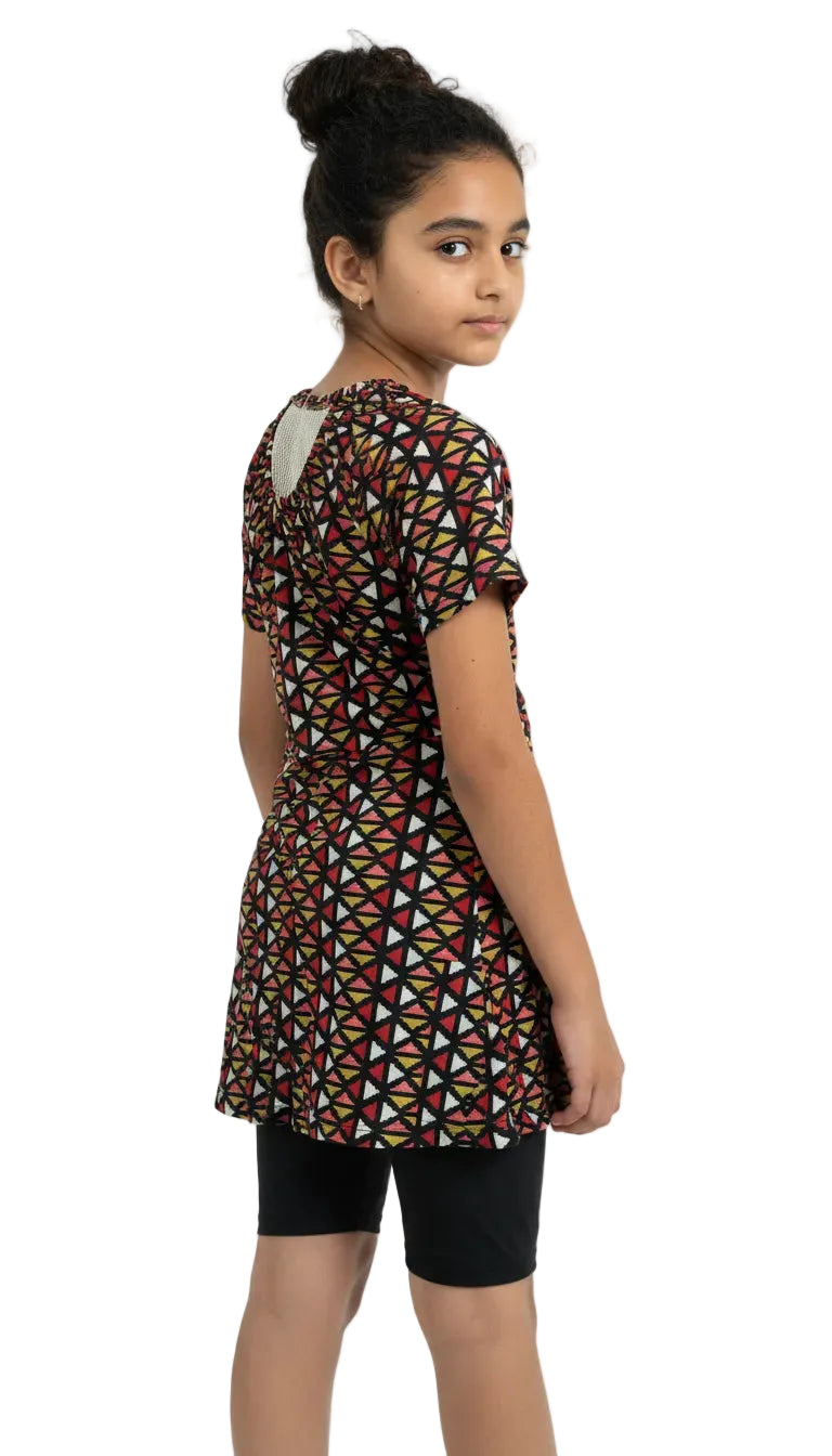 Girl wearing a patterned dress on a white background