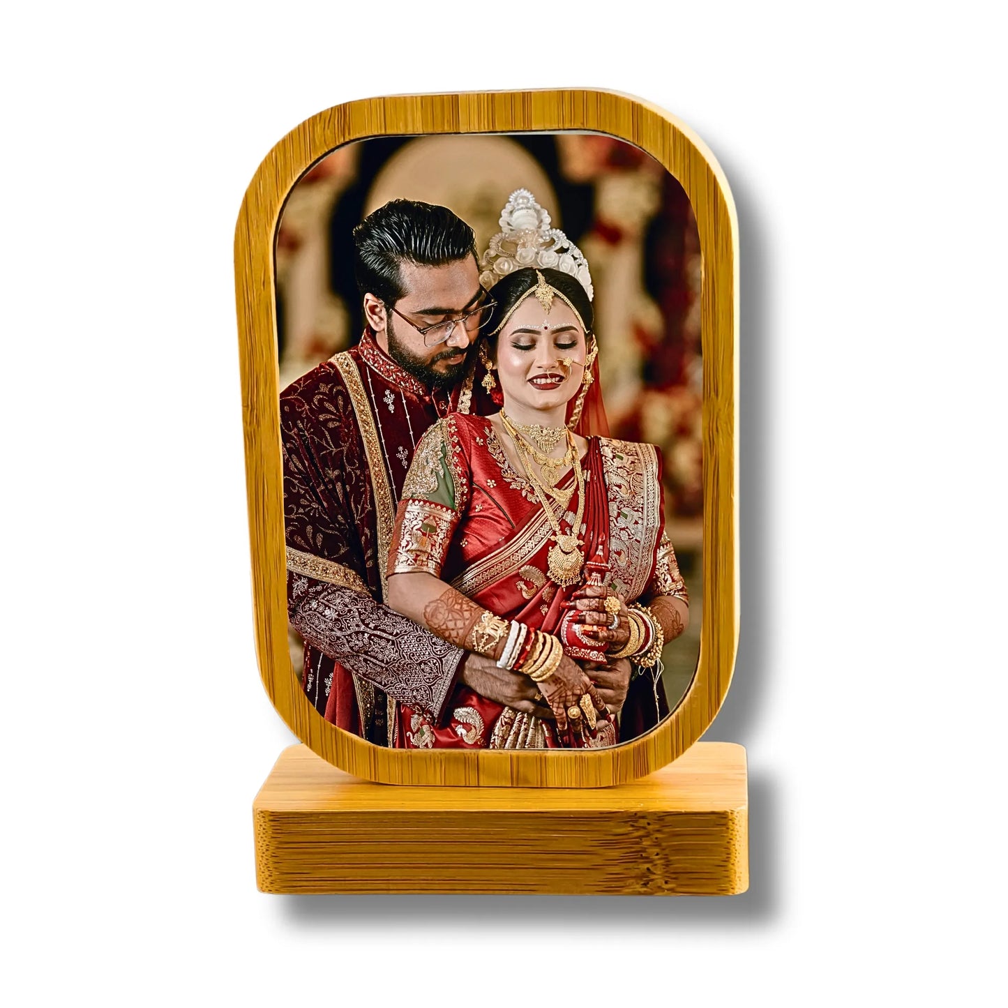 Wooden photo frame with a couple in traditional attire on a white background