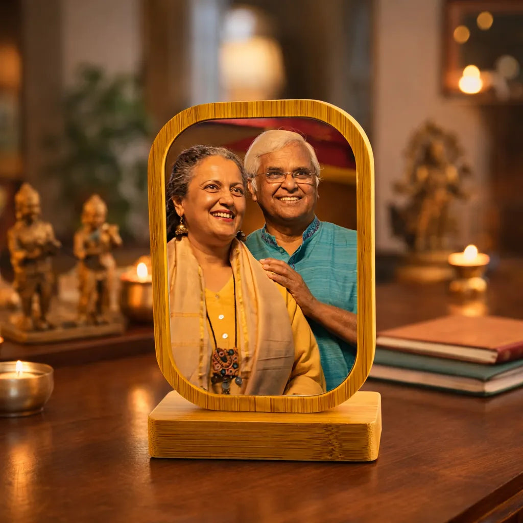 Wooden photo frame with a portrait of an elderly couple on a wooden table.