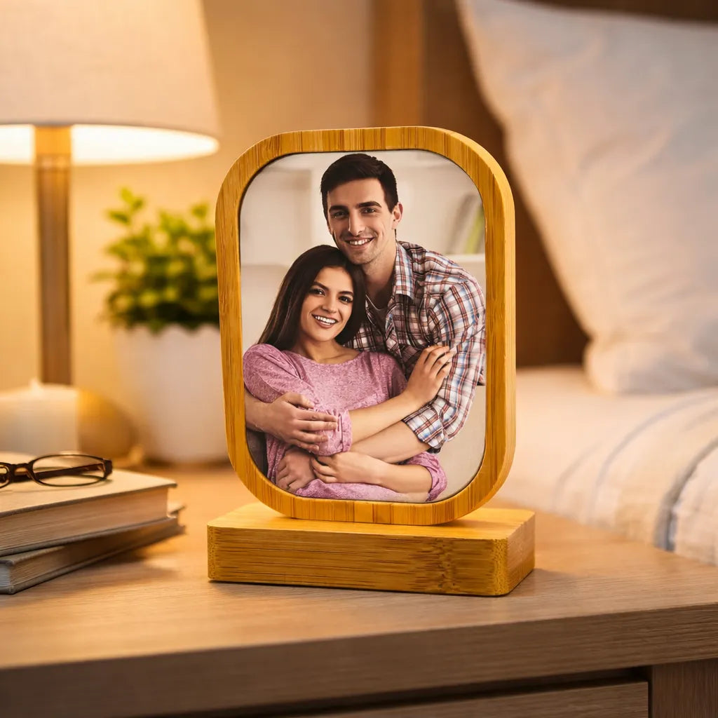 Wooden photo frame with a couple's photo on a nightstand.