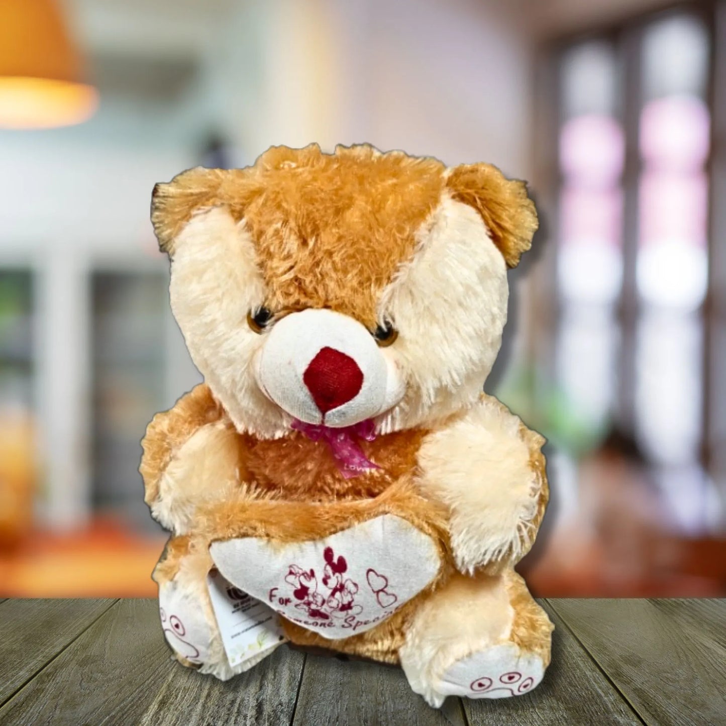 Plush teddy bear with a heart on a wooden surface