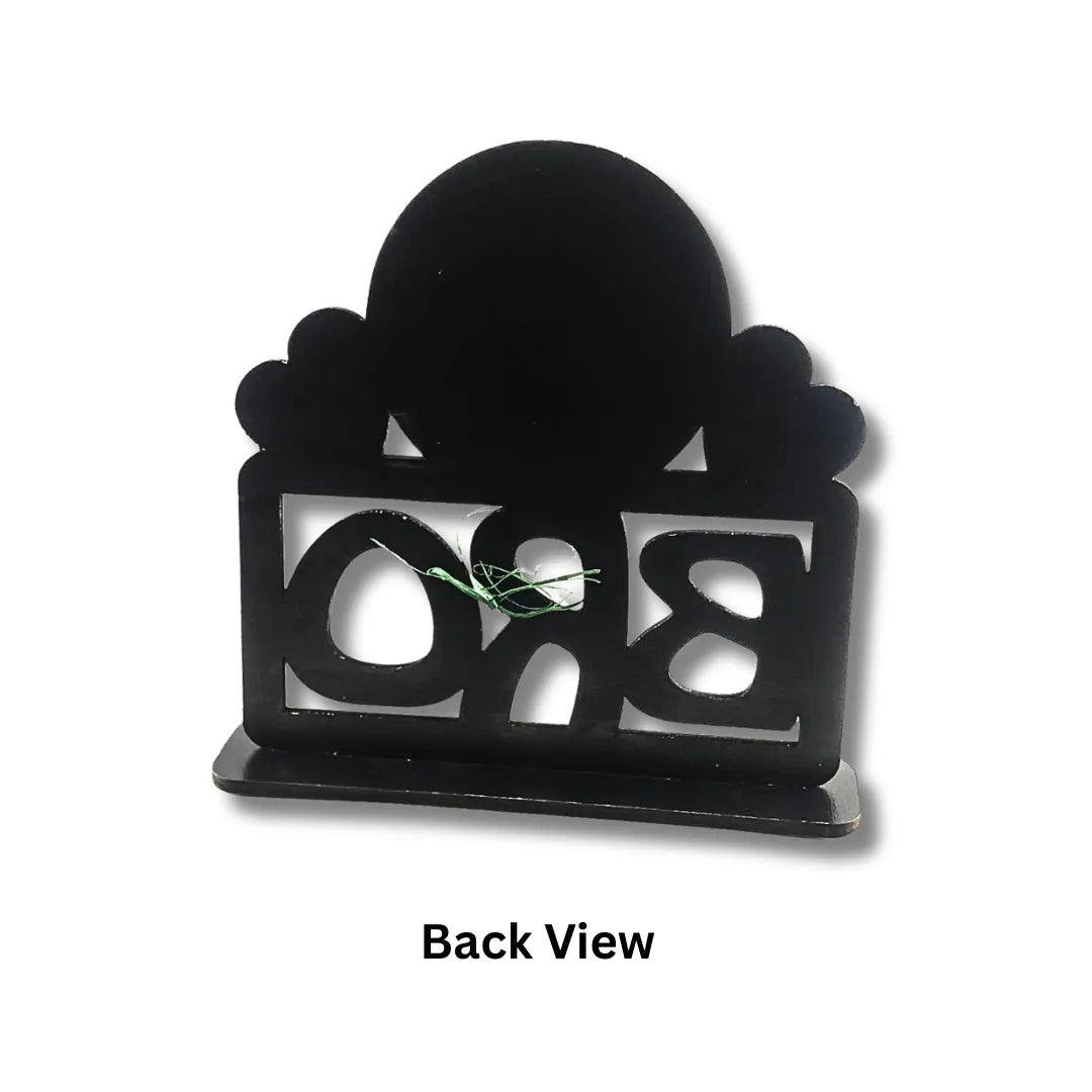 Black decorative item with 'BRO' cutout on a white background