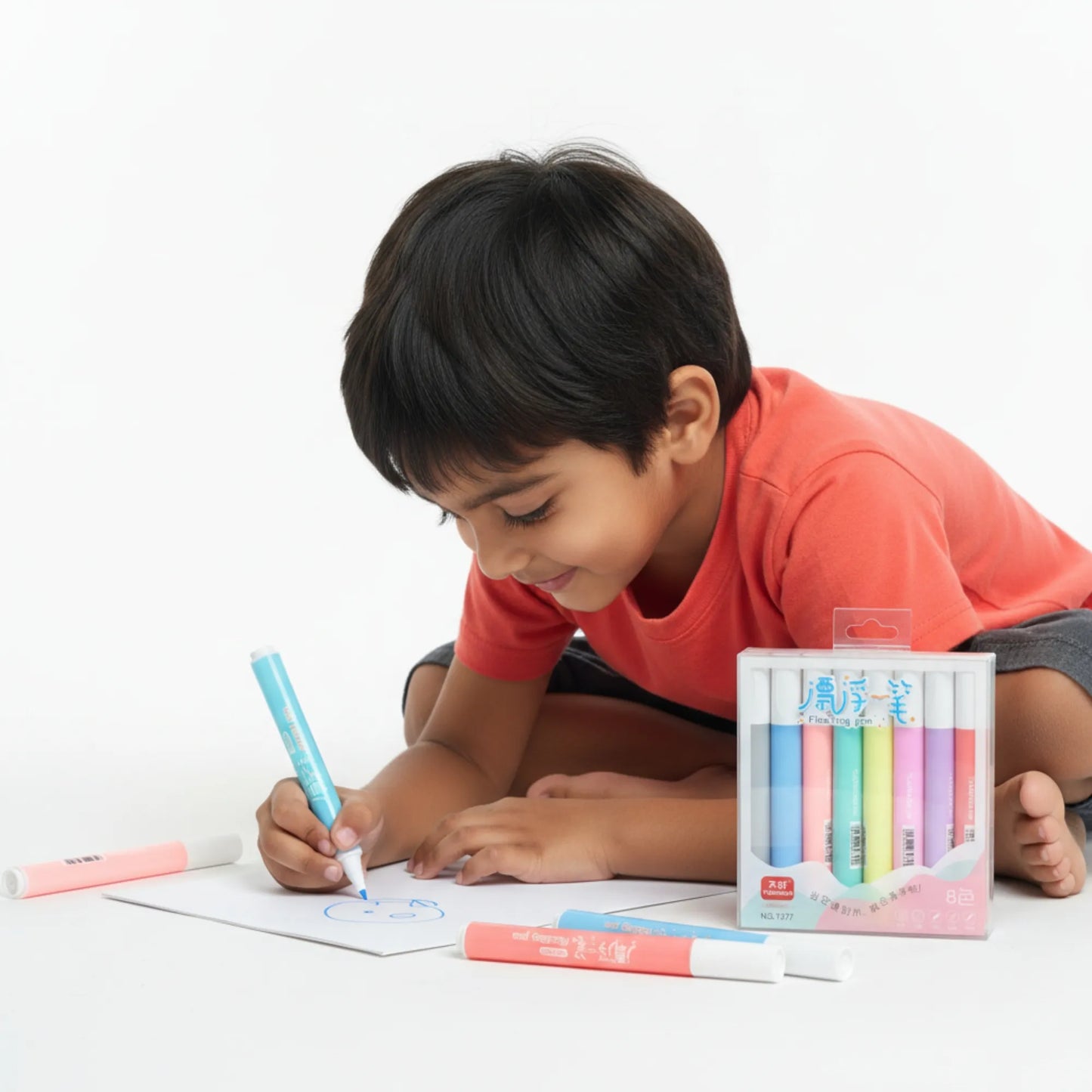 Child drawing with colorful markers on a white surface