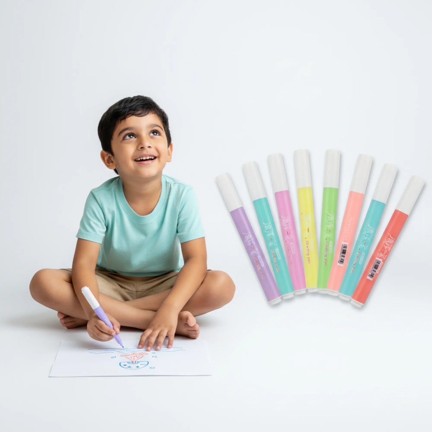 Child sitting on the floor drawing with colorful markers on a white background