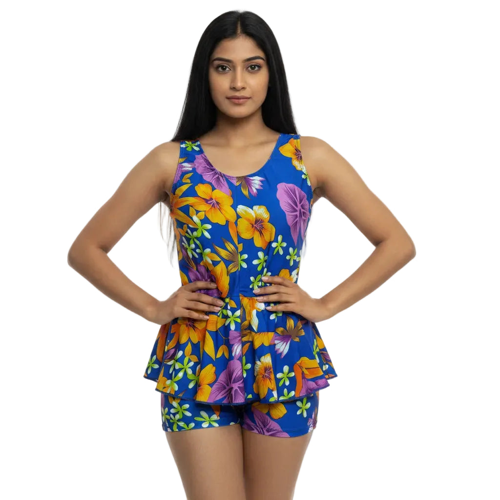 Woman wearing a colorful floral dress with a blue background