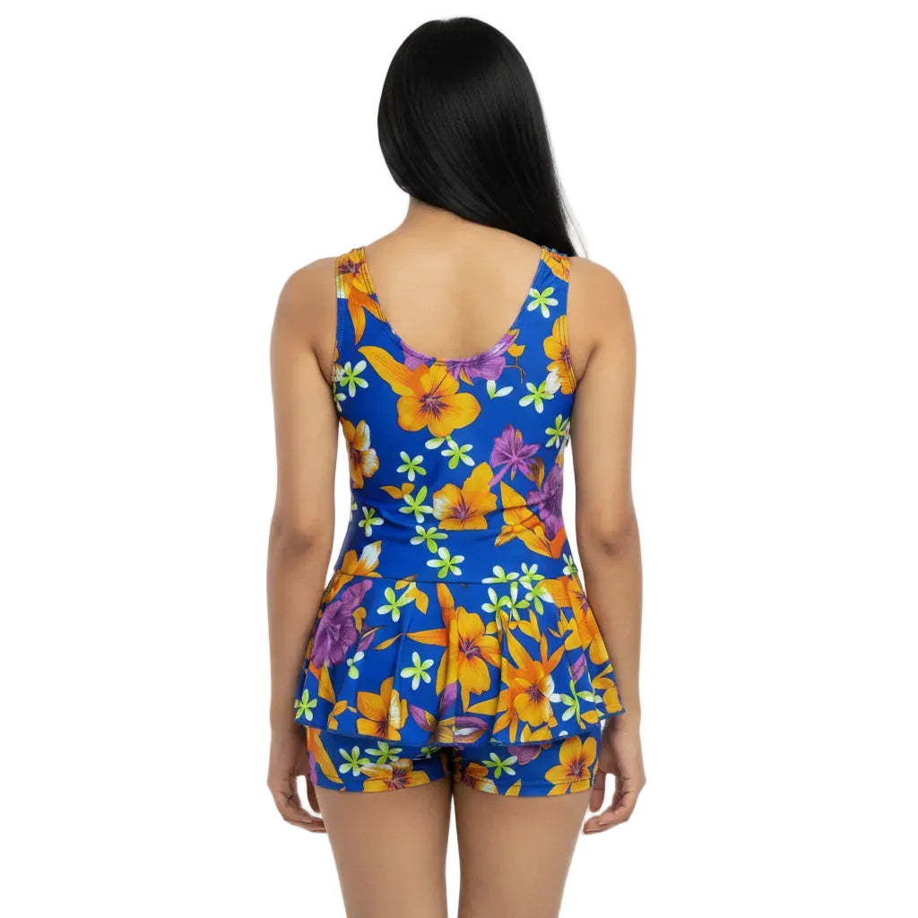 Woman wearing a colorful floral dress on a white background