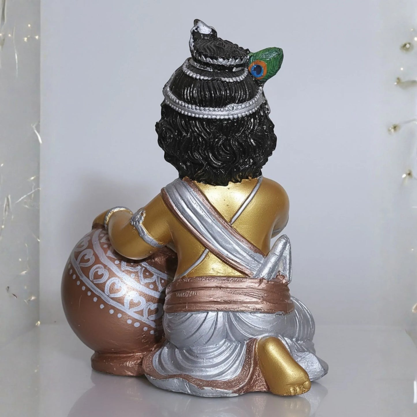 Decorative statue with intricate details on a white background