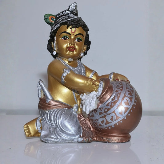 Decorative figurine of a child holding a ball on a white background
