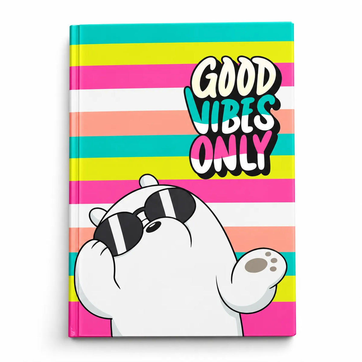 A hardcover notebook with a colorful striped cover featuring the text 'GOOD VIBES ONLY' and an illustration of a white bear wearing sunglasses.