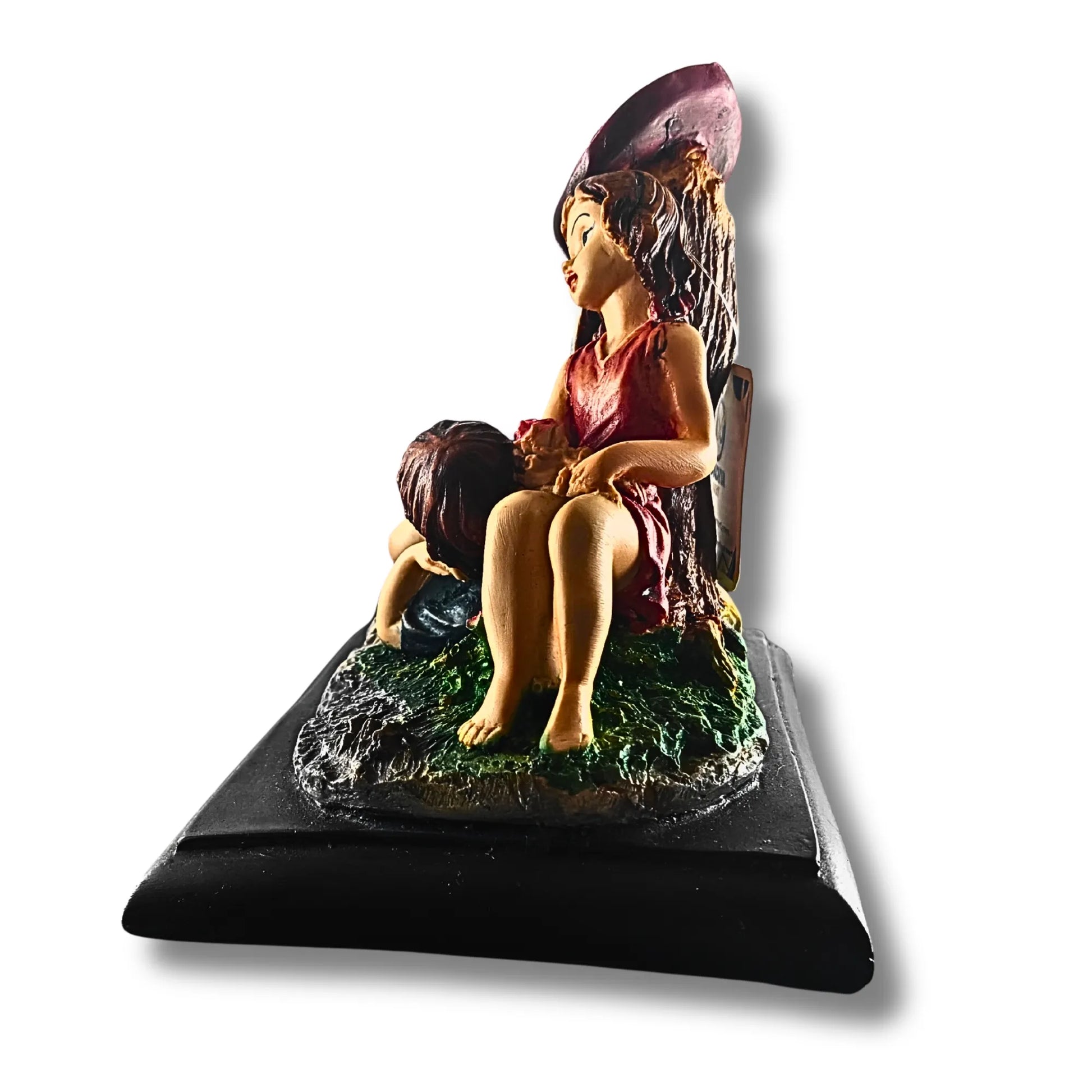 Statue of a woman and child on a black base with a white background