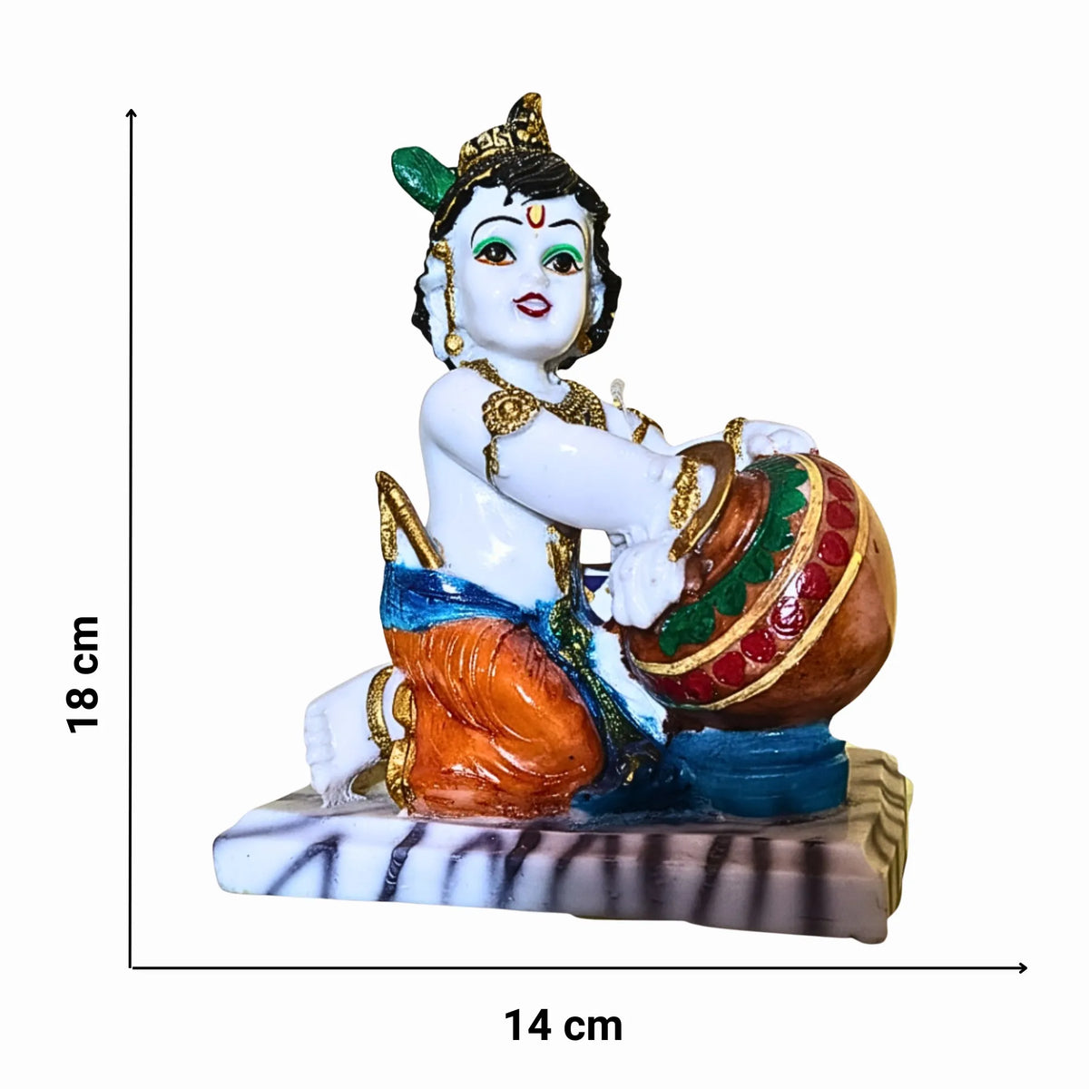 A small decorative figurine of a seated child-like deity holding a drum, shown on a plain white background with measurement markers indicating 18 cm height and 14 cm width.