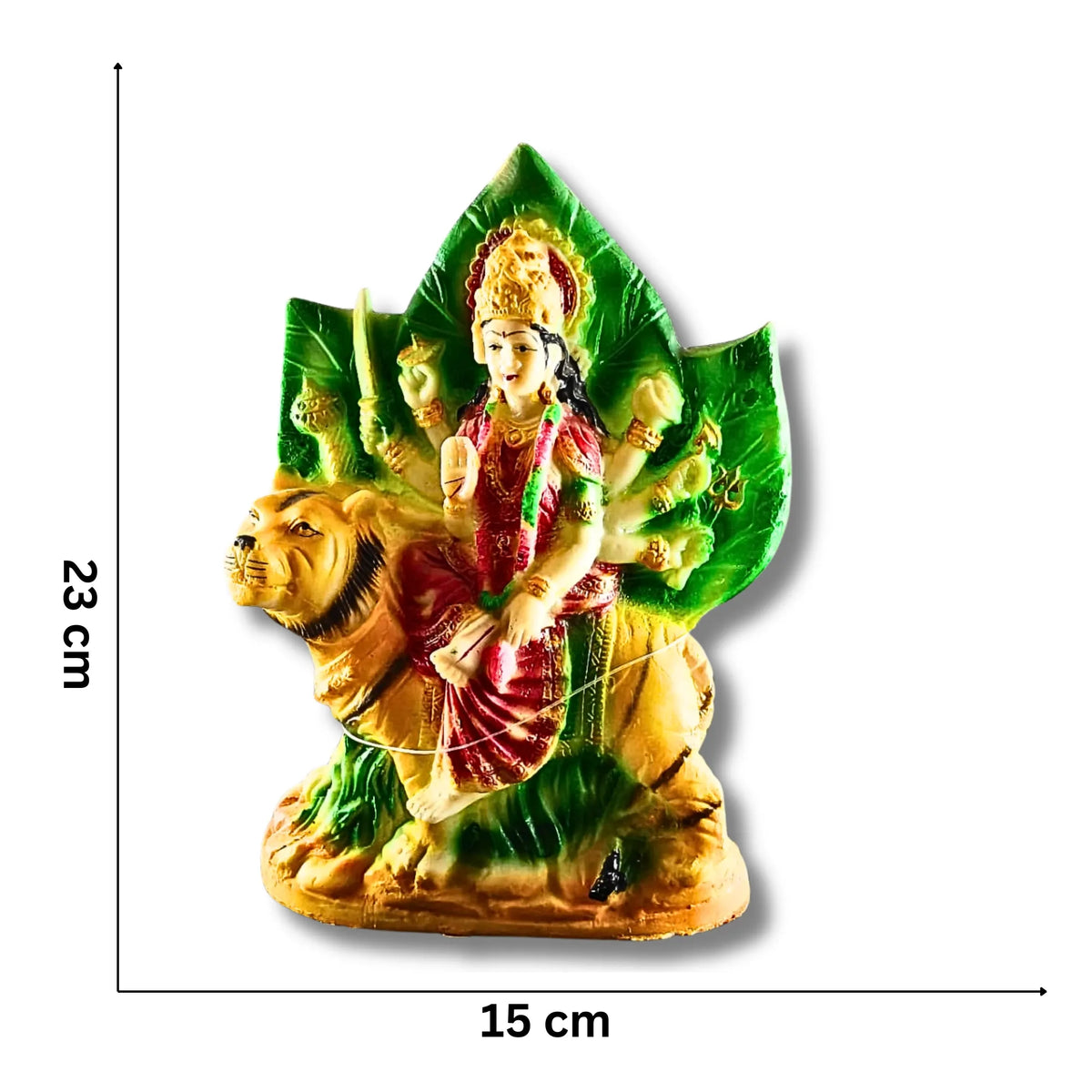 A small multicolored religious figurine of a goddess riding a lion, shown on a white background with black dimension lines indicating 23 cm height and 15 cm width.