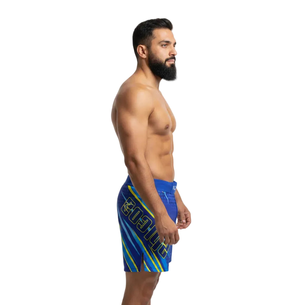Man wearing blue swim shorts with yellow accents on a white background