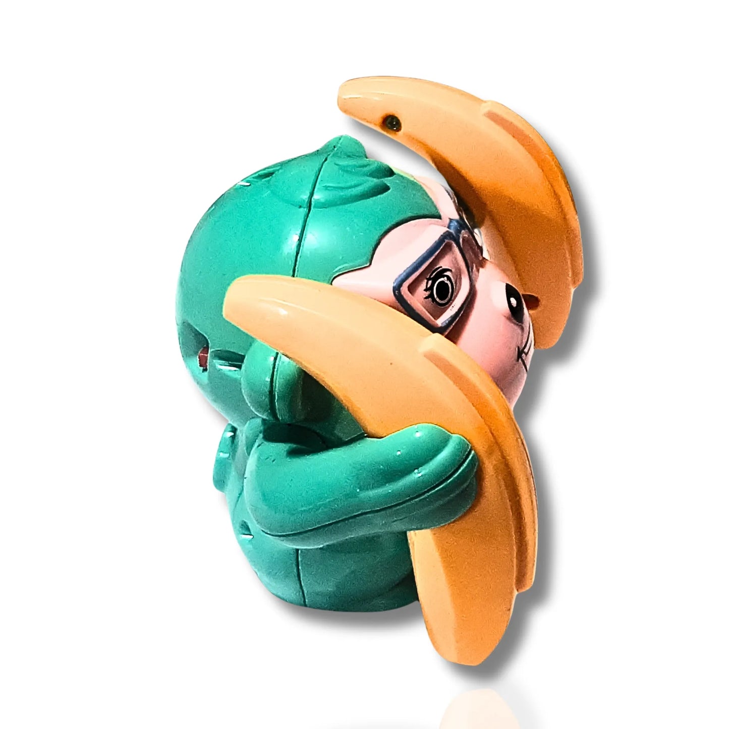 Toy figure with green head and orange hat on a white background