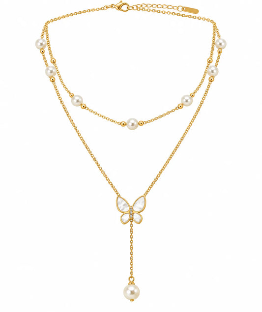 A gold-tone double-strand necklace featuring white freshwater pearls, a butterfly-shaped pendant with pearl wings, and a dangling pearl drop, shown on a plain white background.