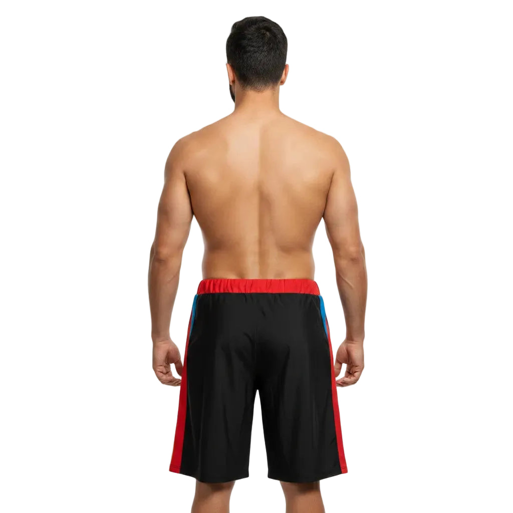 Man wearing black swim shorts with red and blue accents on a white background