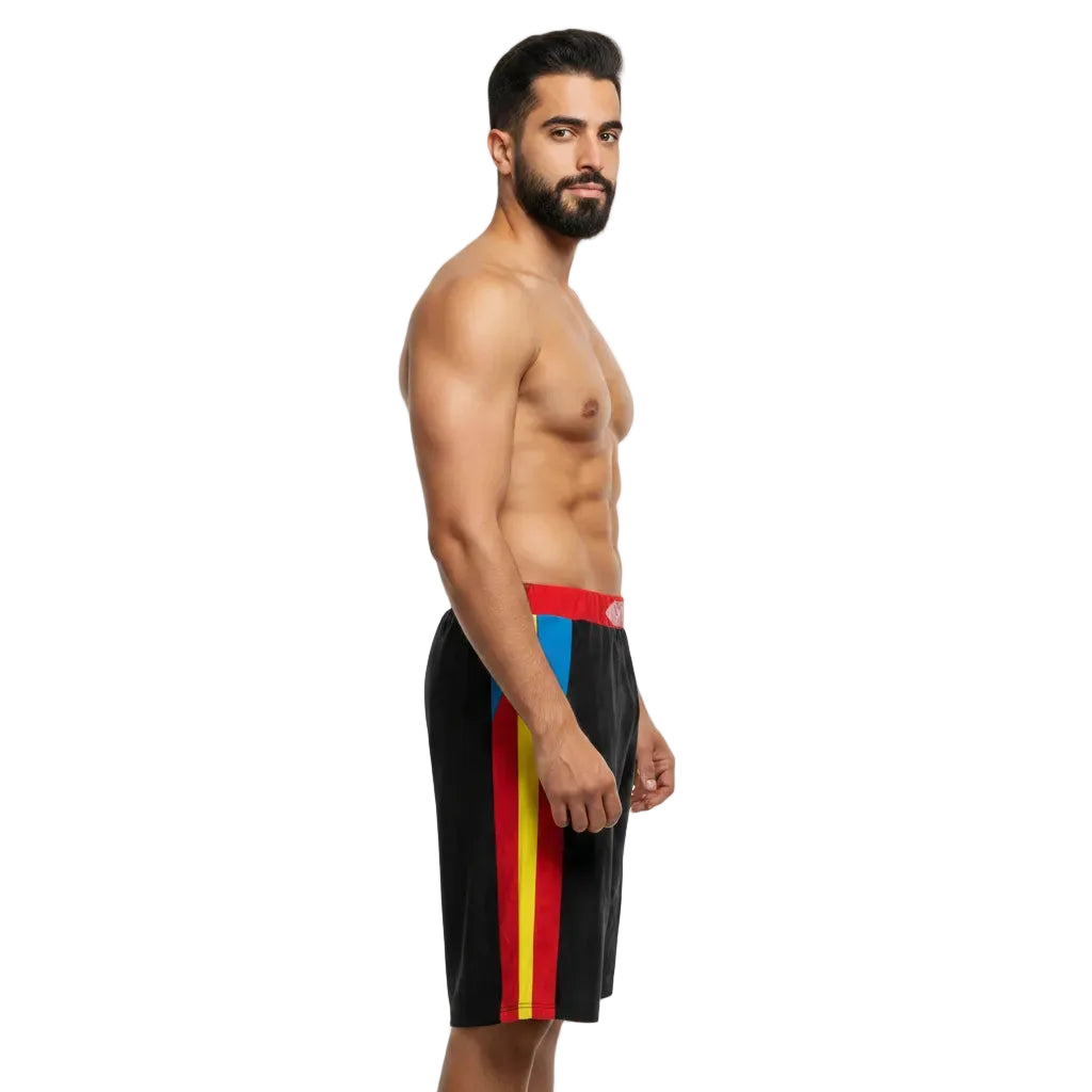 Man wearing black swim shorts with colorful stripes on a white background