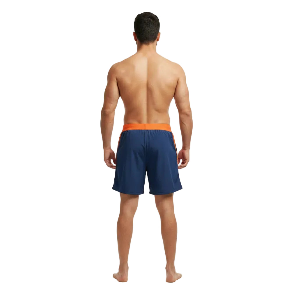 Man wearing navy swim shorts with orange waistband on a white background