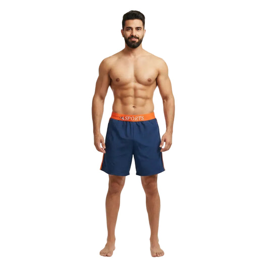 Man wearing navy blue athletic shorts with orange waistband on a white background