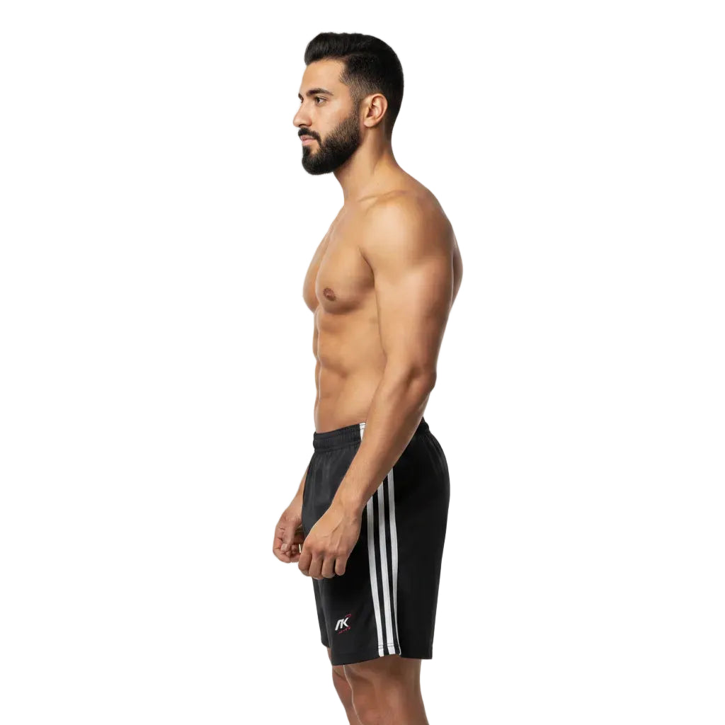 Man wearing black athletic shorts with white stripes on a white background