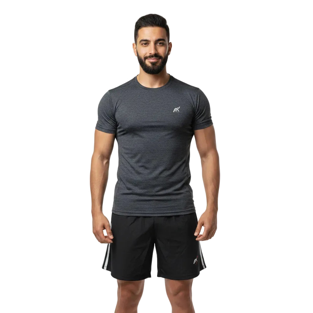 Man wearing a gray athletic shirt and black shorts on a white background