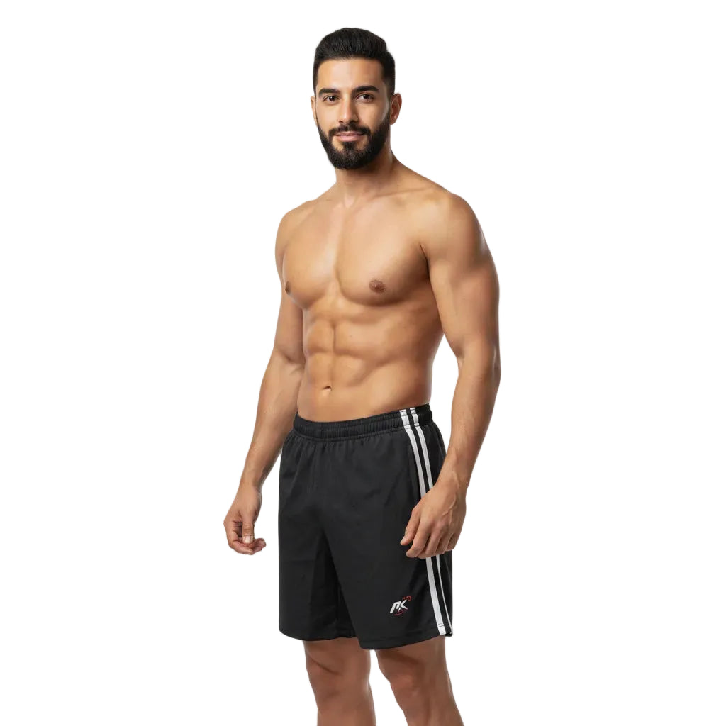 Man wearing black athletic shorts with white stripes on a white background