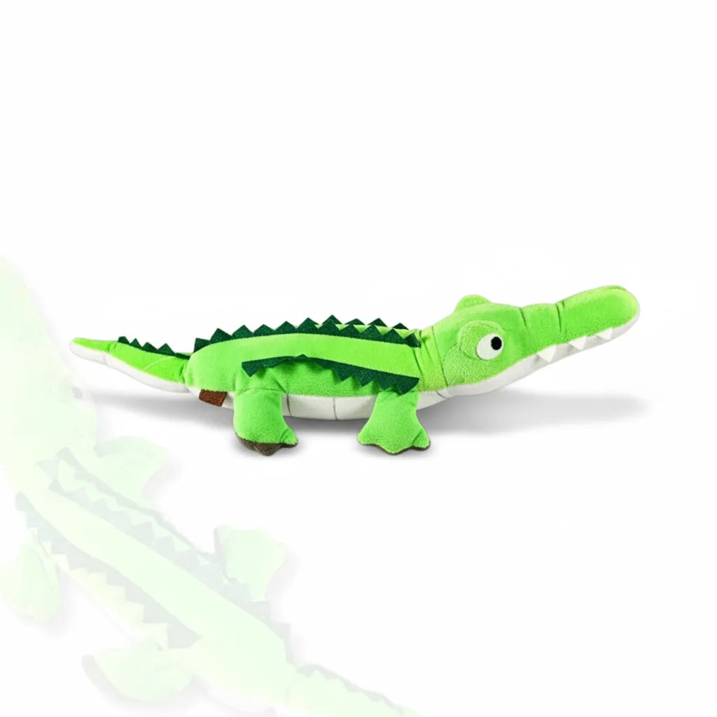 Green plush toy alligator on a white background