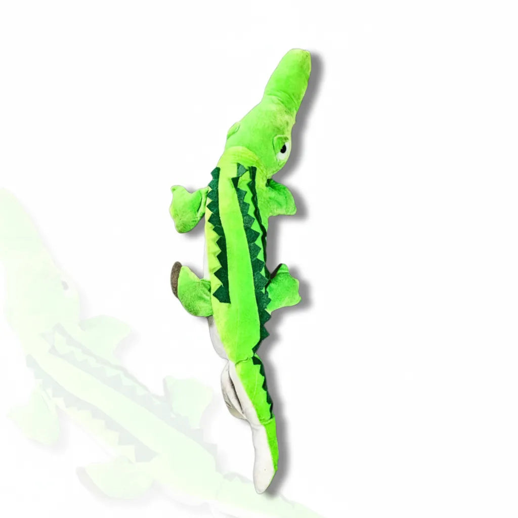 Green plush toy resembling a lizard on a white background