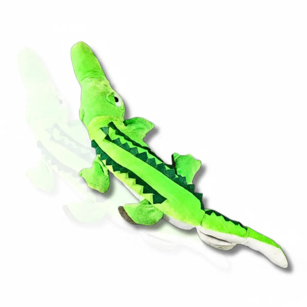 Green plush toy alligator on a white background