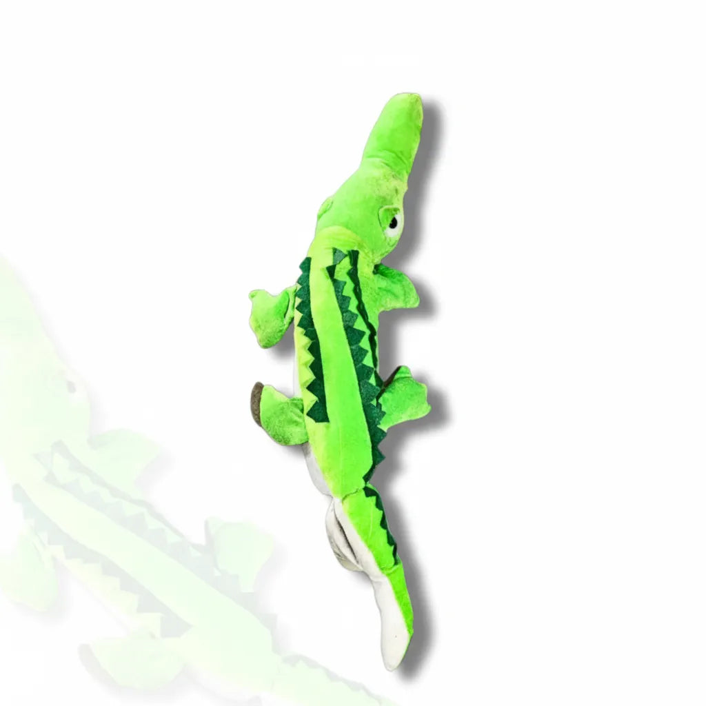 Green crocodile-shaped plush toy on a white background
