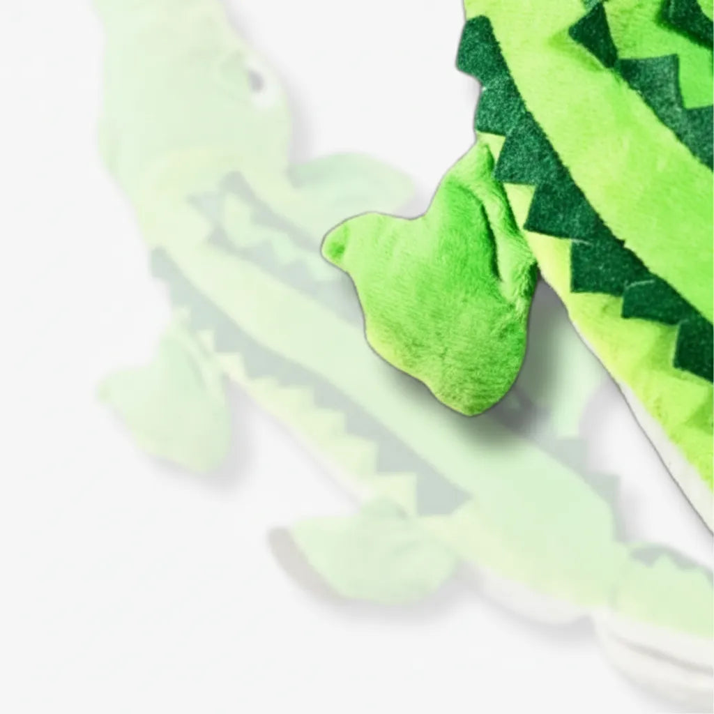 Green dinosaur toy with a white background