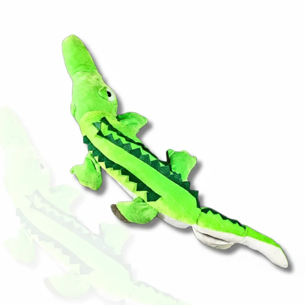 Green plush alligator toy on a white background