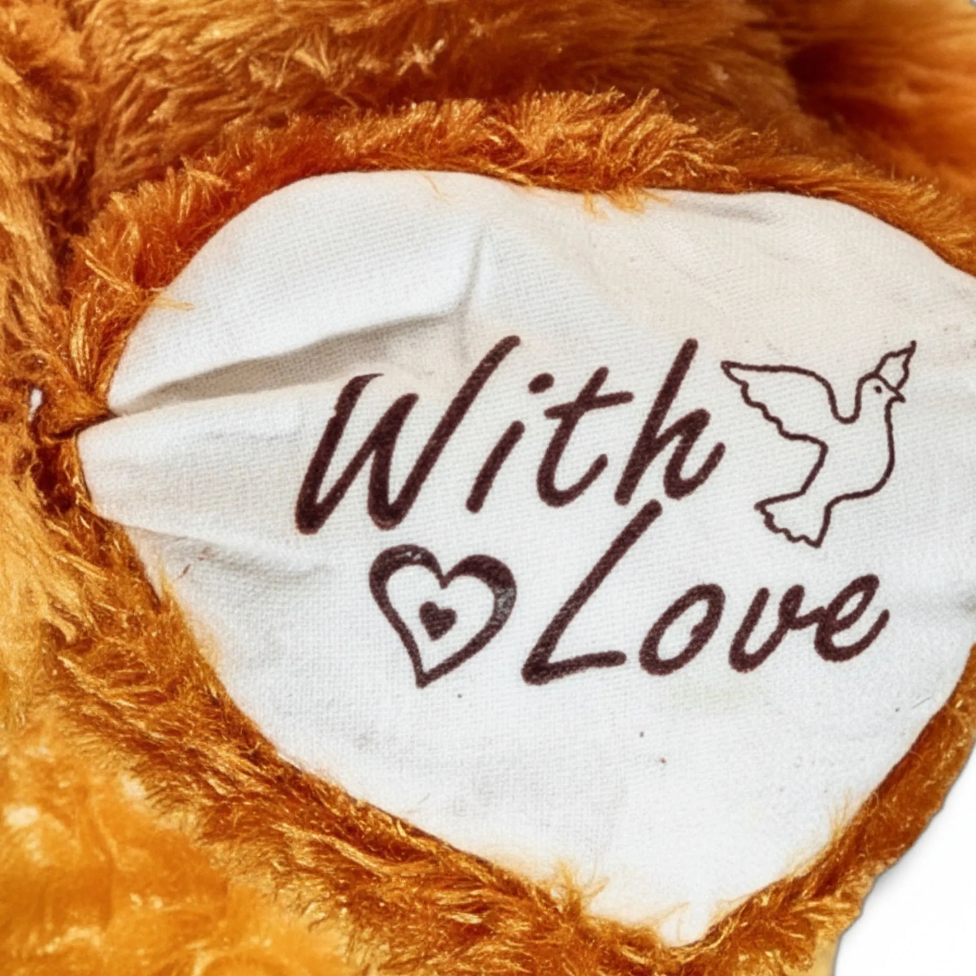 Close-up of a plush toy paw with 'With Love' text on a soft brown background