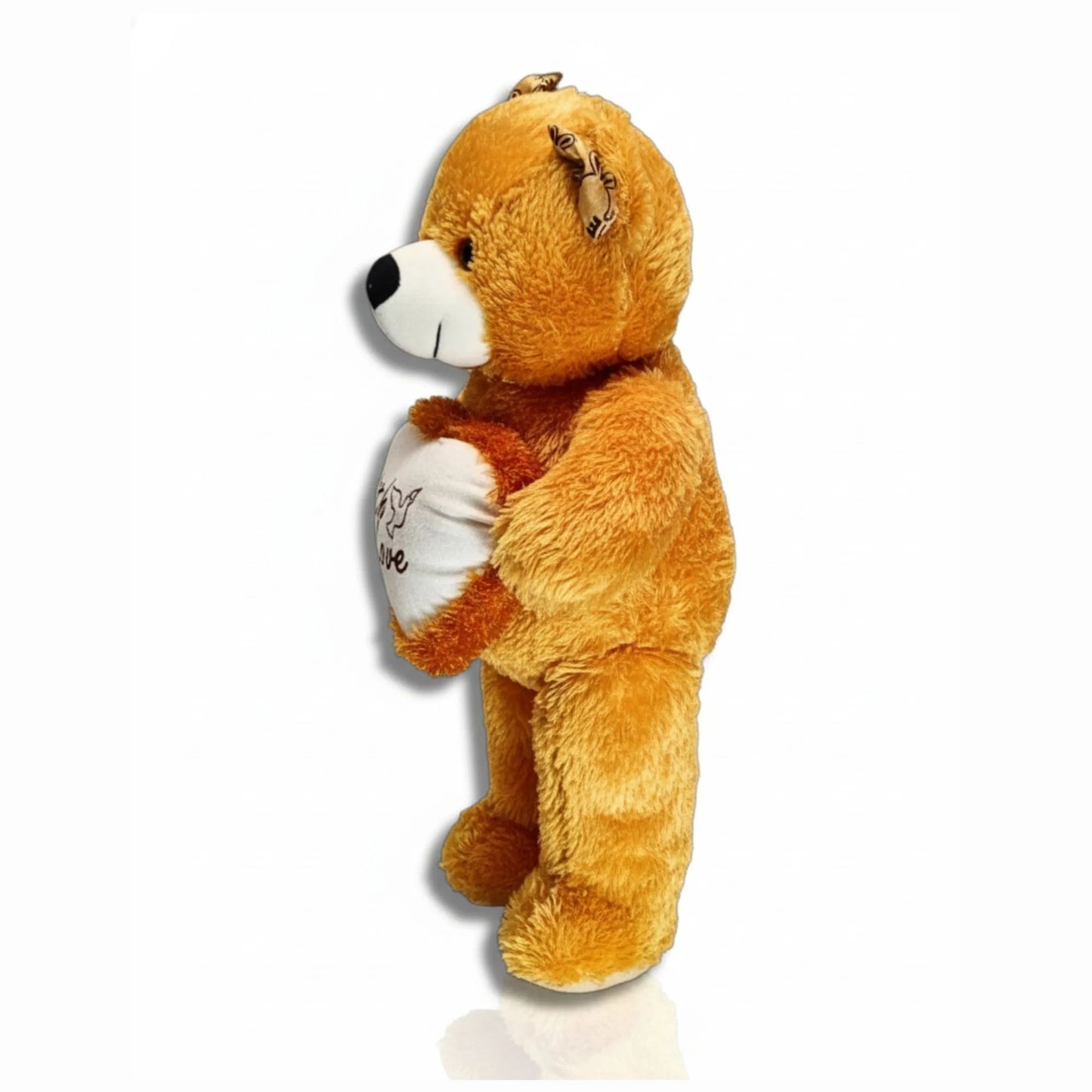 Plush teddy bear holding a heart with 'I love you' on a white background