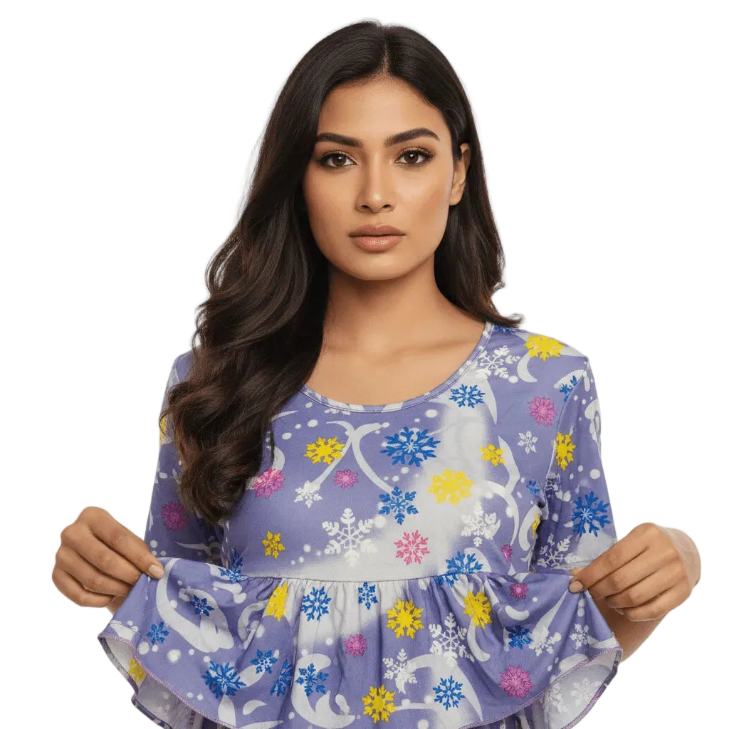 Woman wearing a purple dress with colorful floral patterns on a white background