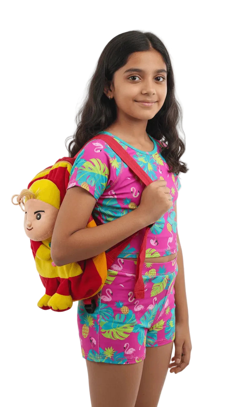 Girl wearing a colorful swimsuit with a cartoon backpack on a white background