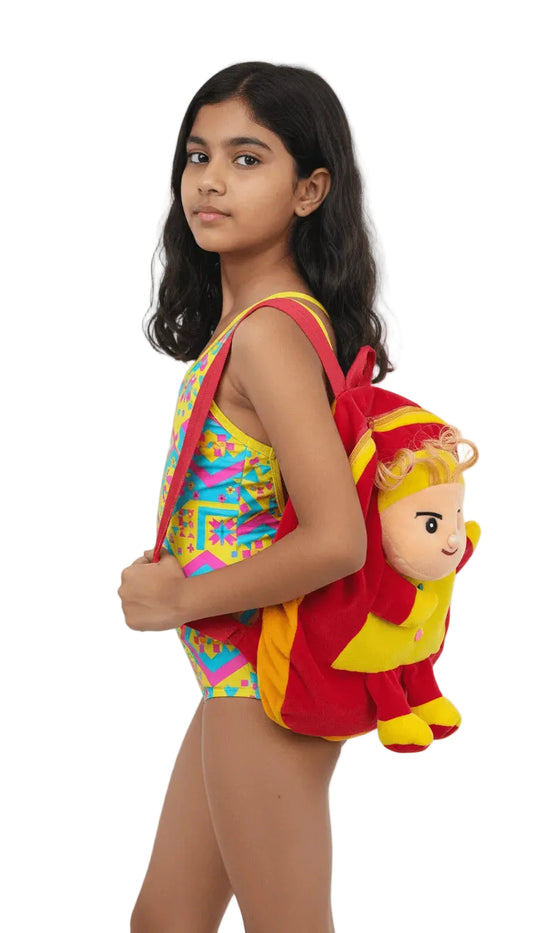 Young girl wearing a colorful swimsuit with a red backpack featuring a cartoon character on a white background