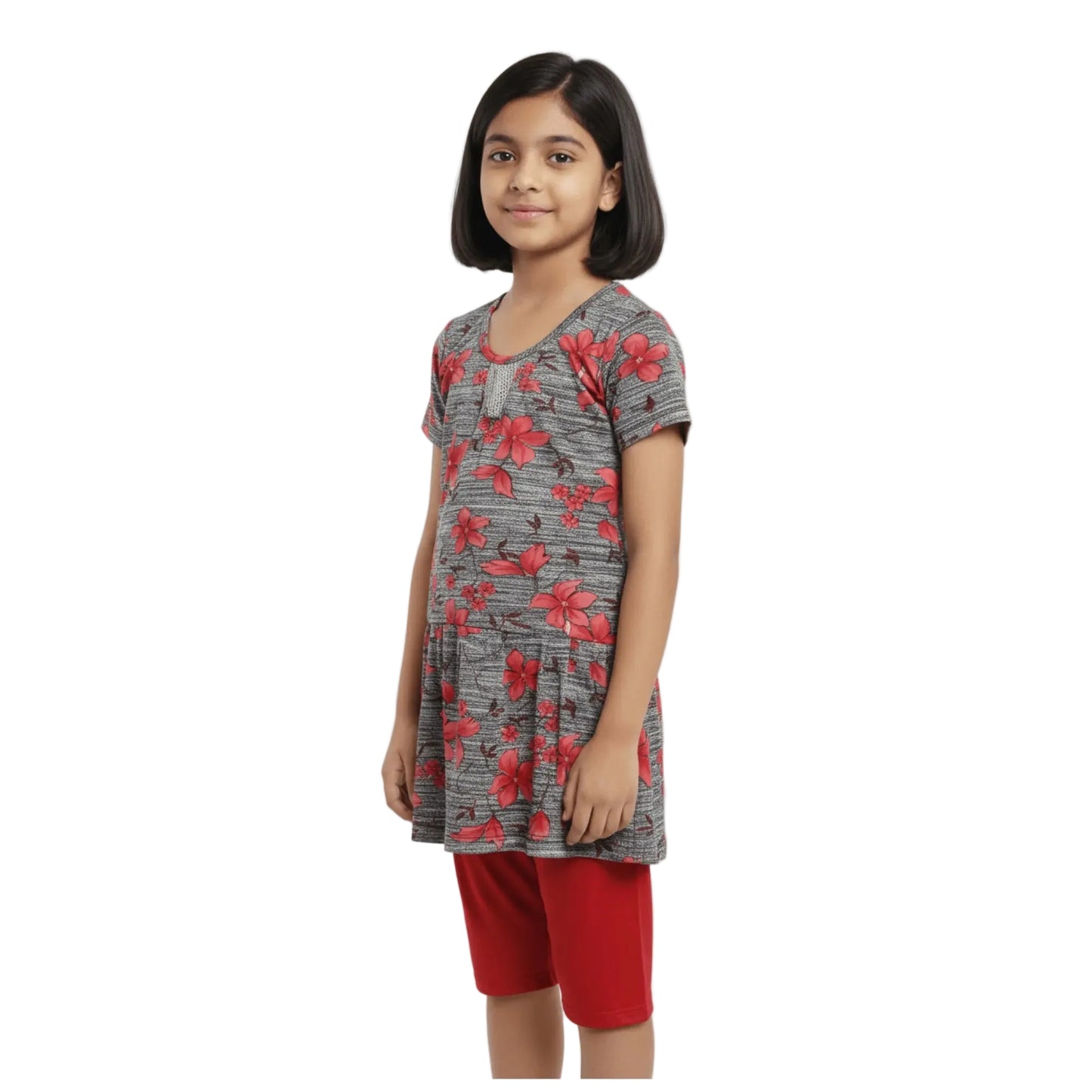 Young girl wearing a gray floral top and red shorts on a white background