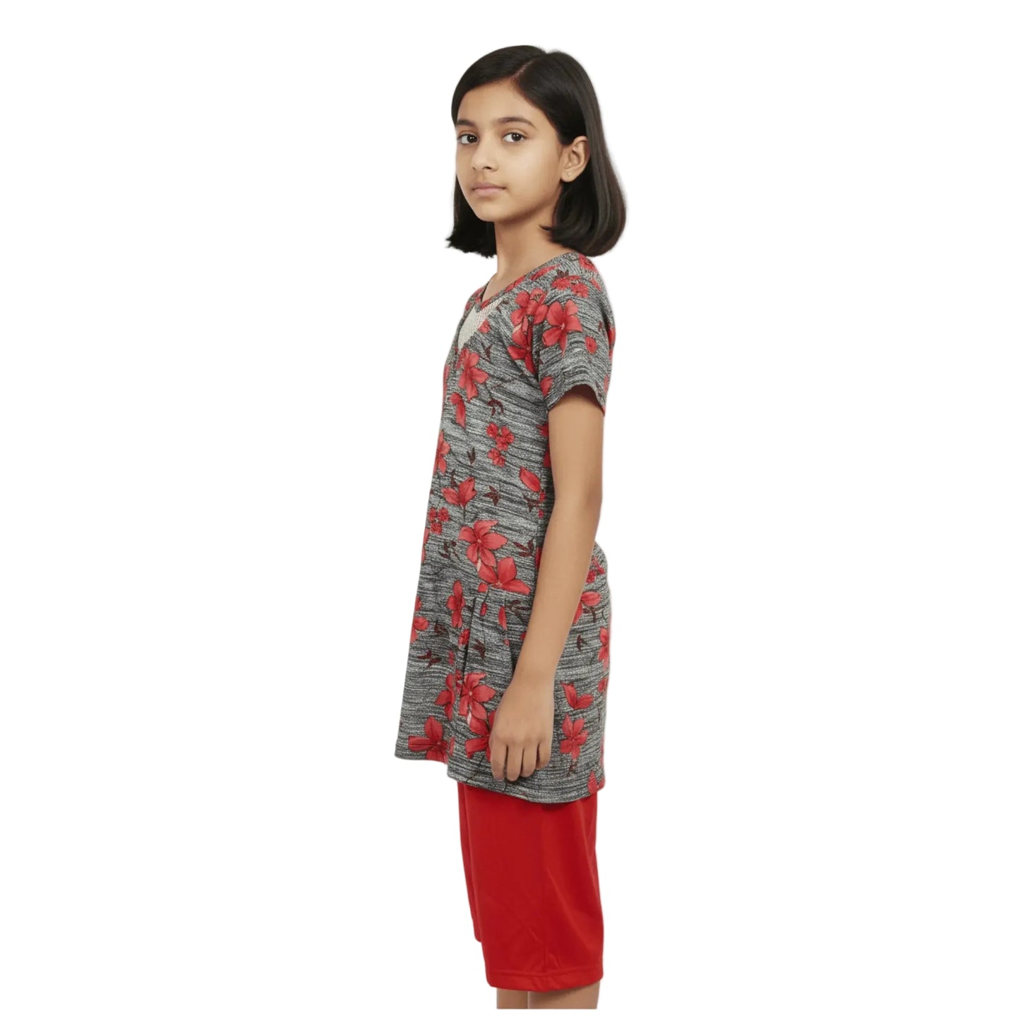 Girl wearing a gray dress with red floral pattern on a white background