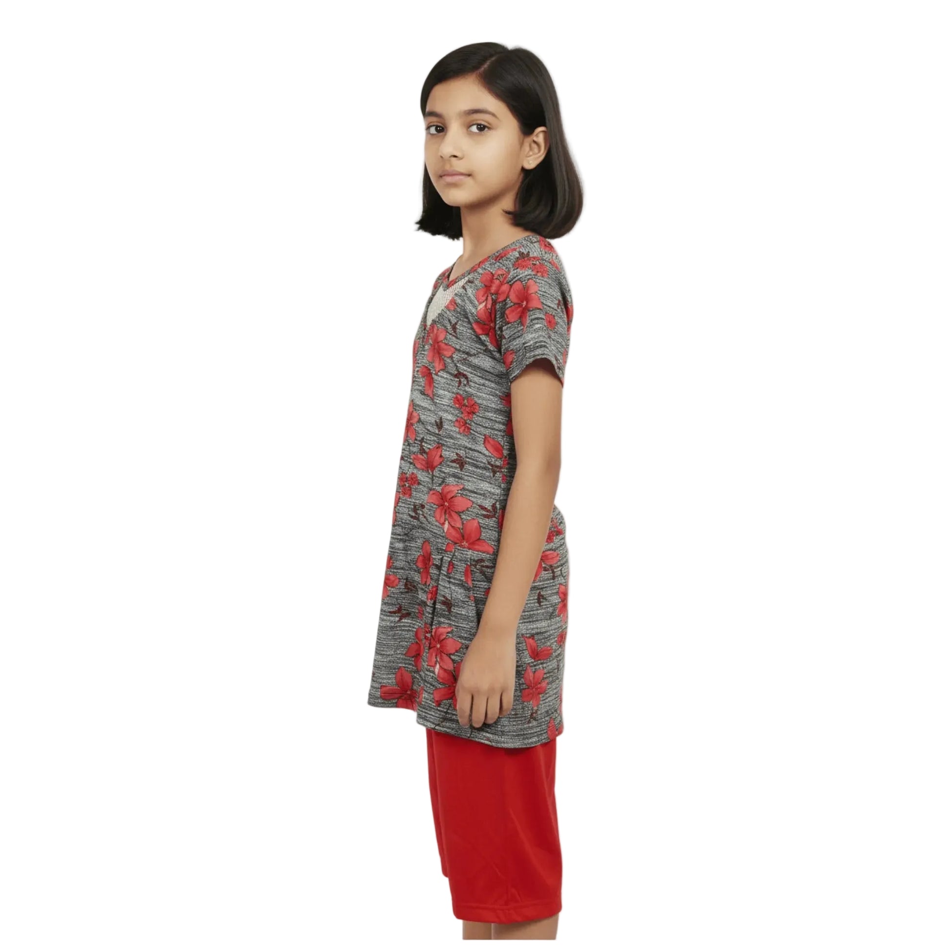 Girl wearing a gray dress with red floral pattern on a white background