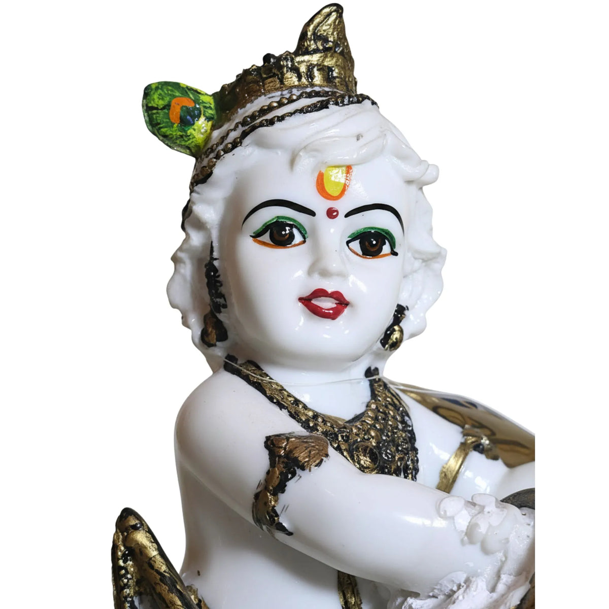 A white porcelain figurine of a baby Krishna wearing a gold crown and jewelry, set against a plain white background.