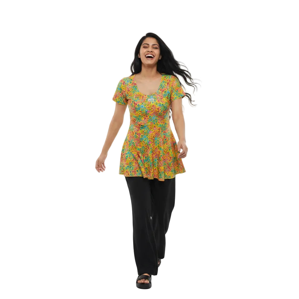 Woman wearing a colorful floral dress on a white background