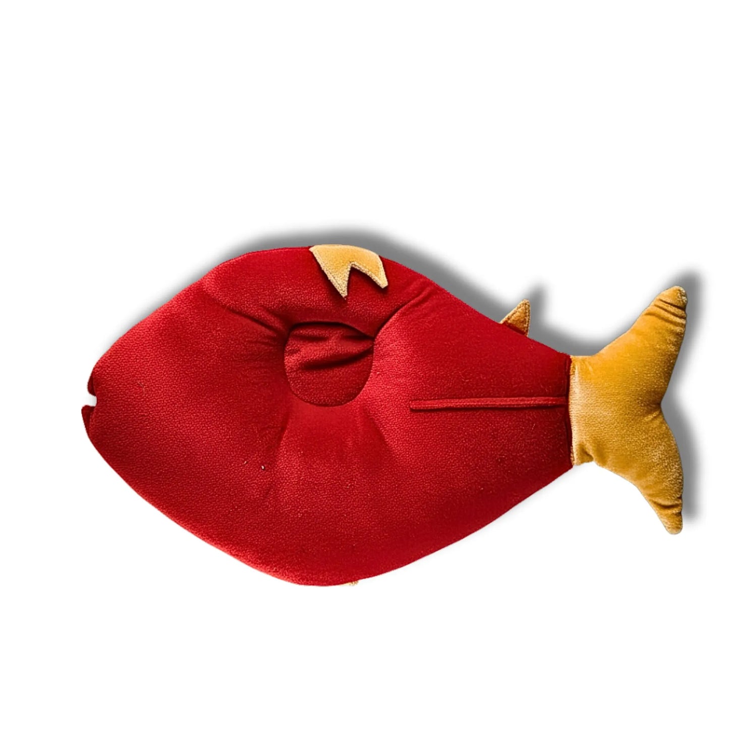 Red and yellow fish-shaped pillow on a white background