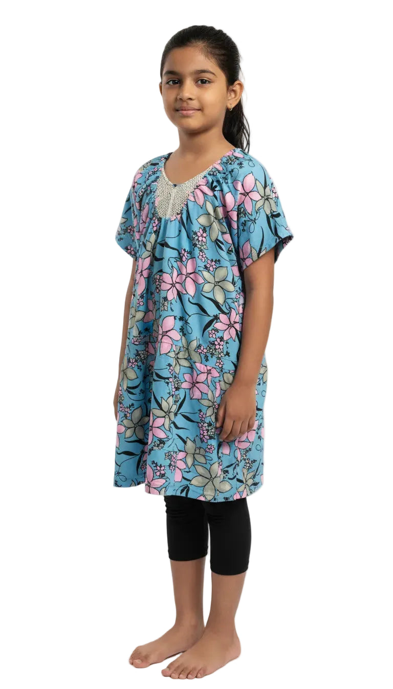 Young girl wearing a blue floral dress on a white background