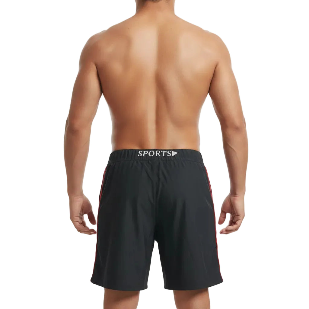 Person wearing black sports shorts with a visible brand logo on a white background