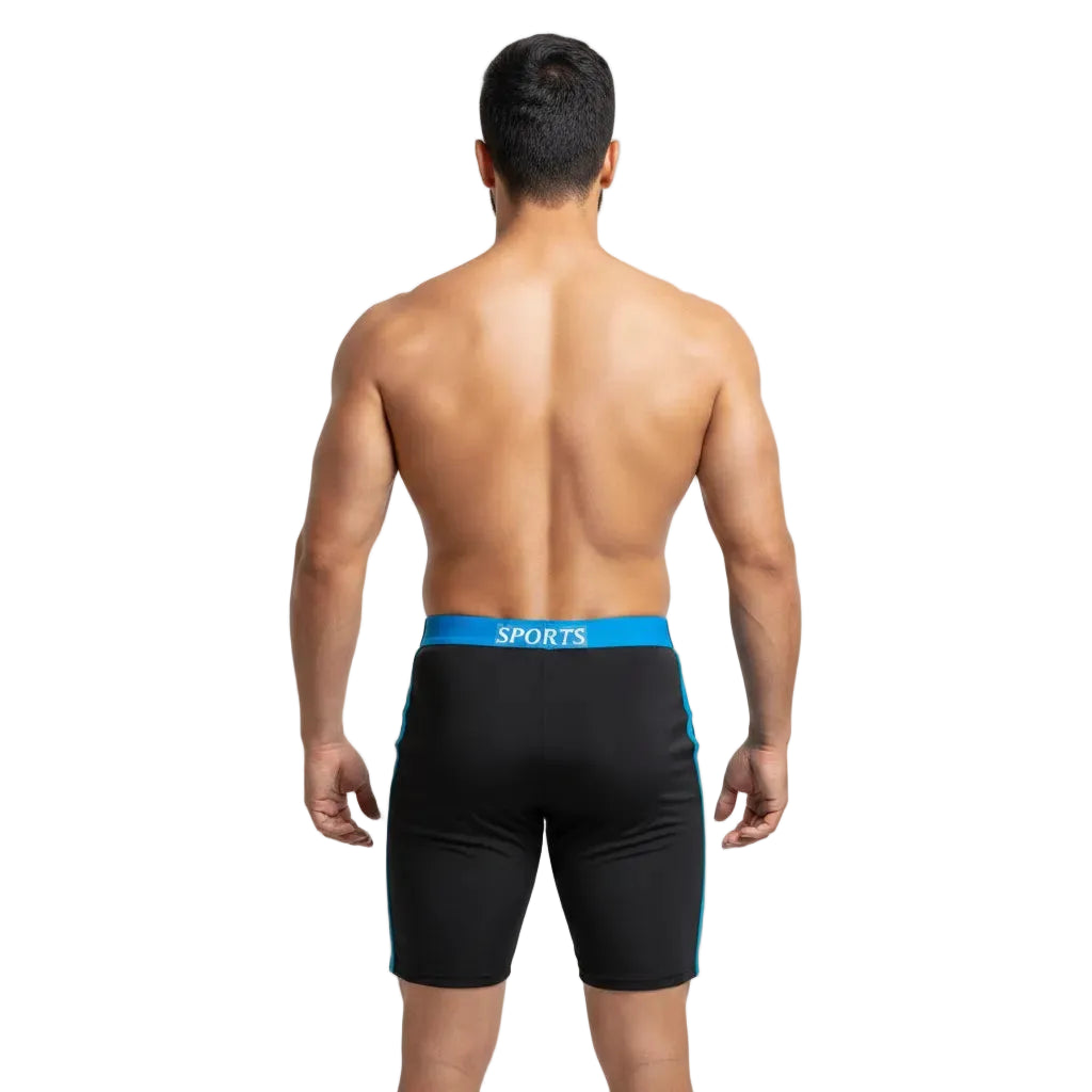 Man wearing black swim shorts with blue waistband on a light gray background